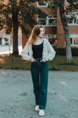 Fashion female portrait of young pretty trendy girl posing at the city in Europe,autumn street fashion.