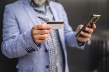 close up of man buy online shopping on mobile phone with credit card