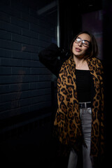 A Stylish Woman Wearing a Leopard Print Scarf and Trendy Glasses Captures Attention