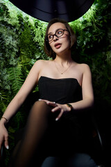 A stylish woman struts into the bar at night, exuding elegance and seduction of nightlife