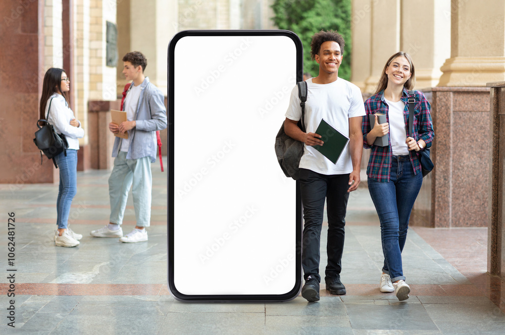 Poster a diverse group of students strolls through a university corridor, pass by huge phone with blank scr