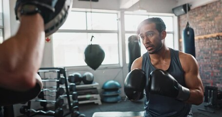 Athlete, boxing and coaching in gym for fight, exercise and learning with help, workout and training. Men, boxer and personal trainer for sports, teamwork and growth with martial arts and fitness