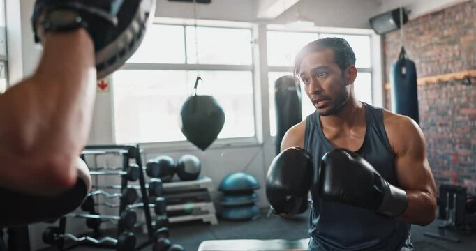 Athlete, boxing and coaching in gym for fight, exercise and learning with help, workout and training. Men, boxer and personal trainer for sports, teamwork and growth with martial arts and fitness