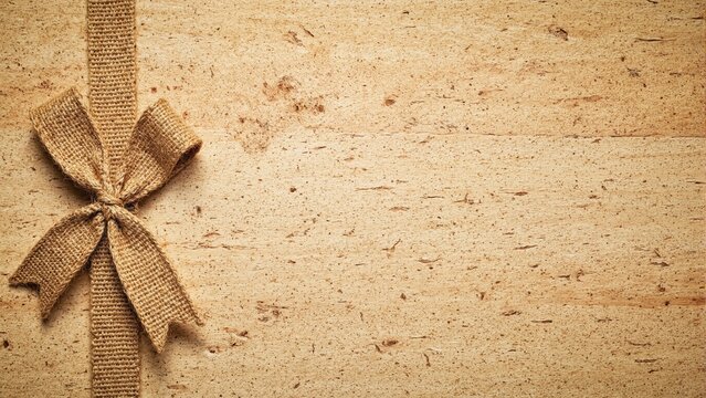 Jute ribbon and bow on rustic wood surface Earthy organic vibes