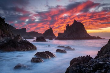 Sunset Over Rocky Coastline with Vibrant Sky