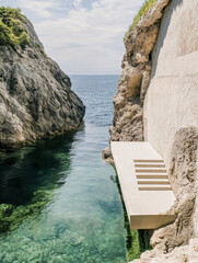 modern stairs to a small island in the sea