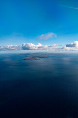 Aerial view looking up the Isle of Man from the south with scenic coastline and clouds - Portrait