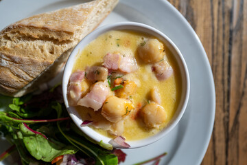 Manx national dish of Queen scallops in a creamy sauce with bread and salad