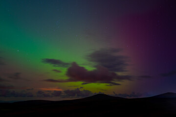 Northern lights over Snaefell mountain in Isle of Man night sky