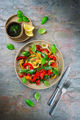 French style summer ratatouille salad with roasted vegetables served as top view with vinaigrette balsamic dressing on a design plate