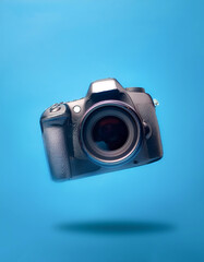 DSLR Camera with blank logo floating or flying isolated on light blue background
