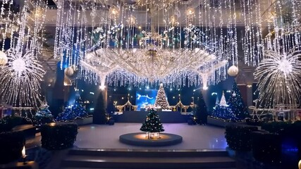 Lighting technicians prepare a luxurious hotel stage for a festive christmas party with elegant decorations and vibrant lights