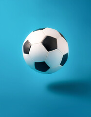 Fototapeta premium White and black soccer ball floating or flying isolated on light blue background