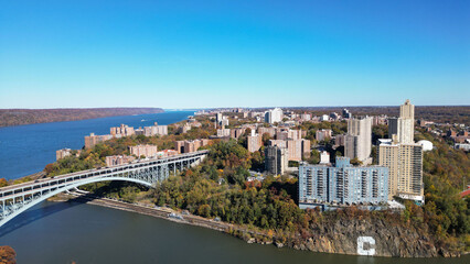 This location in the Bronx offers stunning views of lush greenery, a picturesque lake, and urban structures. Framed by the river, it showcases iconic bridges and the New York City skyline 