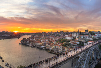 Fototapeta premium Scenic view of the city of Porto in Portugal in warm sunset light with boats and Douro river