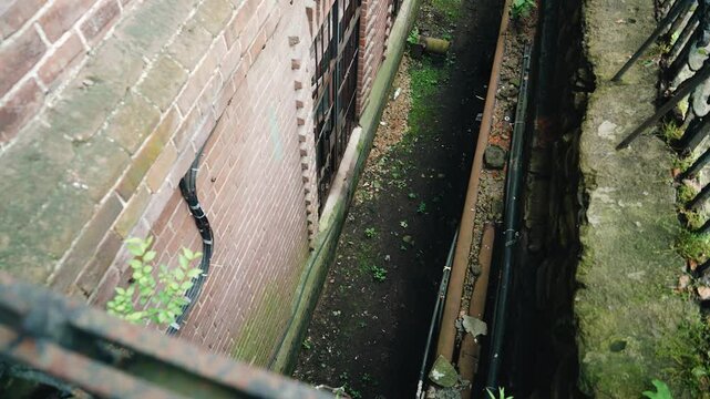 The lower ground floor of the old building is slightly overgrown with old. Top-down view