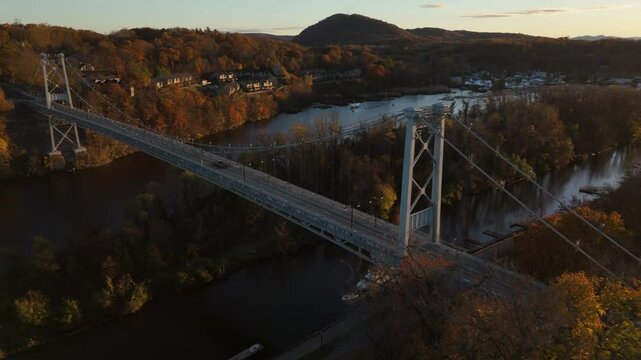 flying clockwise view of sunset over Kingston Port Ewen Bridge