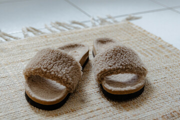 Stylish pair of slippers made of natural sheepskin.