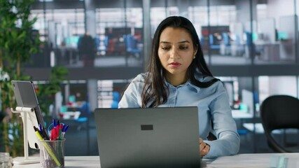 Professional expert beams with excitement celebrating latest work accomplishment. Female executive enjoys satisfaction of achieving business win, marking a breakthrough for the company. Camera A.