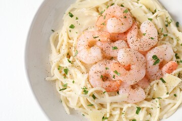 Delicious pasta with shrimps and cheese on white table, top view