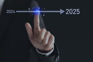 New year goals. Businessman touching arrow leading from 2024 to 2025 on virtual screen against black background, closeup