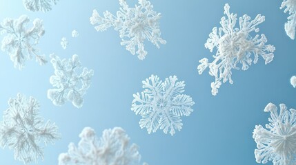 Array of snowflakes with frosty details, soft blue background for copy
