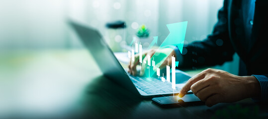 Businessman Analyzing Stock Market Growth on Digital Interface with Laptop and Smartphone Showing Financial Data, Green Arrows, Positive Trading Indicators, Strategic Planning for Future Investment