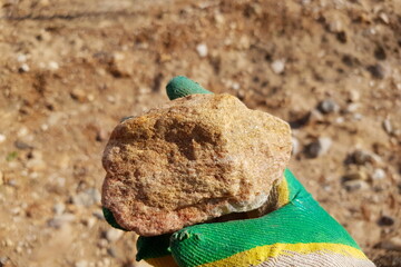 Rough fragment of natural aventurine - quartzite with shiny mica, field photo