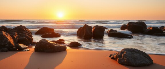 Obraz premium Golden Hour Sunrise on Sandy Beach with Rocks and Ocean Waves