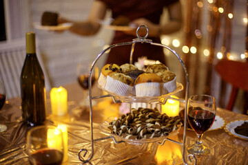 Bottle of Red Wine, Sweets and Cake. Table setting for birthday celebration party at home.