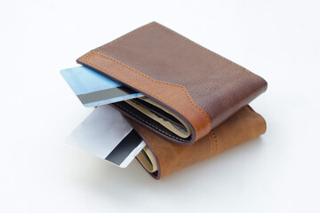 Brown wallet with credit card on white background.