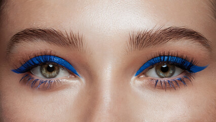 Obraz premium Electric Blue Mascara, Bold Minimalism: A front-facing close-up of both eyes, where each lash is coated in vibrant electric blue mascara, standing out strikingly against natural, makeup-free skin