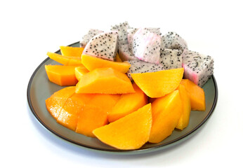 slices of mango and dragon fruit on white background