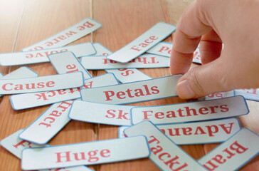 hand picking up cards in class