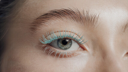 Fototapeta premium stylish minimalism, Pastel Blue mascara: a close-up shot of an eye adorned with vibrant Pastel Blue mascara on naturally long lashes