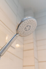 closeup, modern chrome shower head in bathroom.