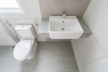 Luxury bathroom with white ceramic sink and toilet.