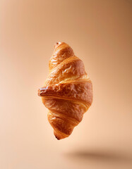 Croissant floating or flying isolated on biege background