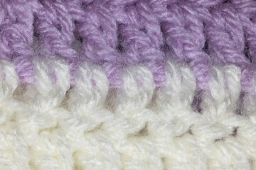 close-up of horizontal crochet stitches of a lilac purple and white blanket, crocheted or knitted, reminds you of grandma's house, cozy and warm macro background