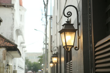old lantern lights installed in narrow alleys to light the way