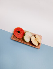 Fresh papaya, apple, and guava on colorful background