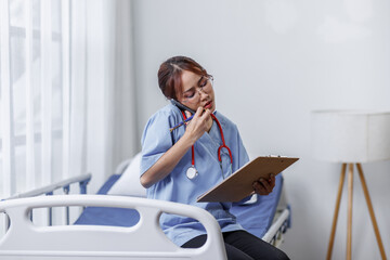 Female doctor or nurse busy about analyzing healthcare treatment on medical documents on bed in hospital