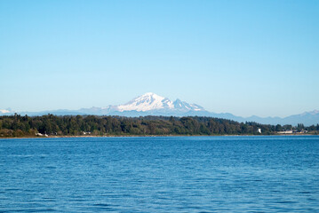 The sea on a summer day in Canada with majestic snowy mountains in the background.