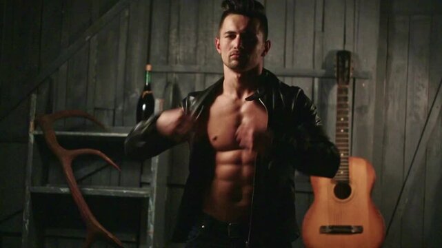 Topless guy undressed shirt. Young sexy man with muscular body takes off his shirt. Sexy male model. Seductive guy. Handsome shirtless man. Muscular male fit body. Male fashion model.