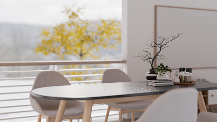 A close-up of a modern dining table by the window in a contemporary white dining room.