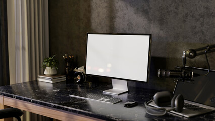 A modern freelance podcaster office workspace featuring a computer, headphones, and a microphone.