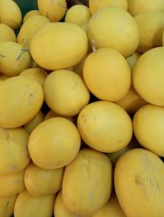 A pile of fresh and tempting yellow-skinned watermelons. Heap of watermelons, close-up