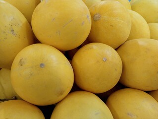 A pile of fresh and tempting yellow-skinned watermelons. Heap of watermelons, close-up