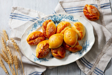 Pies savoury and sweet assortment. Russian traditional pirozhki pastry. Grey background. Top view.