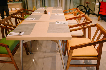 A beautifully set restaurant table featuring elegant dinnerware, soft lighting, and tasteful decor